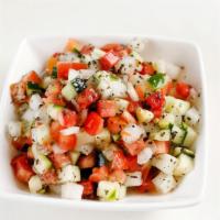 Salad Shirazi · A traditional Persian salad consisting of tomatoes, cucumbers and onions dressed in olive oi...