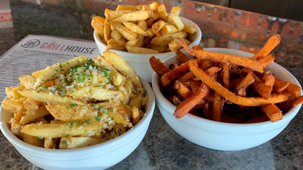 Garlic Fries · House-made Kennebec potato fries tossed in our house garlic seasoning and topped with parmesan cheese