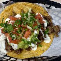 Super Taco de Asada · Our Super Taco is made with a large tortilla topped with Meat, Cheese, Pico de Gallo, Guacam...
