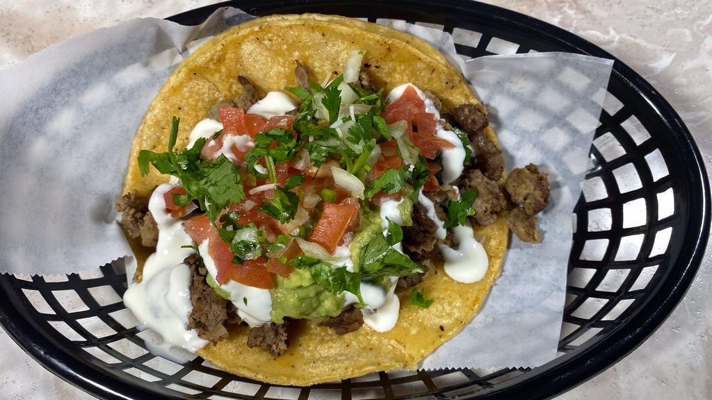Super Taco de Asada · Our Super Taco is made with a large tortilla topped with Meat, Cheese, Pico de Gallo, Guacamole, and Sour Cream. Be sure to add salsa from our salsa and sides sections.