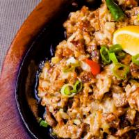 Sizzling Pork Sisig · Diced pork with onions, jalapeno and egg in a creamy lemon soy sauce.
