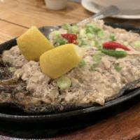 Sizzling Bangus Sisig · Boneless shredded milkfish topped with spices and served on a plate.