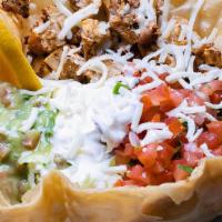 Taco Salad · Served with meat, lettuce, rice, beans,  cheese, fresh salsa, guacamole & sour cream.