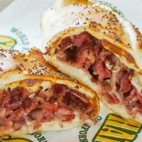 Pastrami Hot Hat Sandwich · Thinly sliced pastrami with melted Swiss cheese stuffed into our pizza dough shell and toppe...