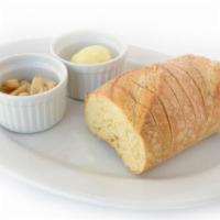 Sourdough & Roasted Garlic · Warm sourdough, a blend of butter & extra virgin olive oil, whole roasted garlic cloves on t...