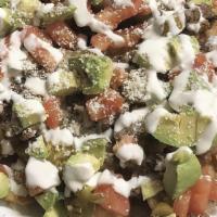 Super Nachos · Meat, beans, cheese, sour cream, avocado, and chiles.