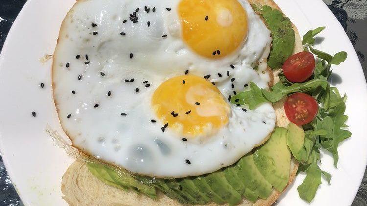Avocado Toast · Two eggs sunny side up, two sourdough toast with avocado.