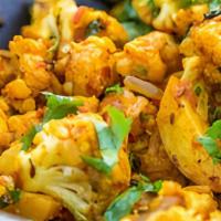 Aloo gobi · It is  a popular Indian dish in which potatoes and cauliflower are cooked with onions, tomat...