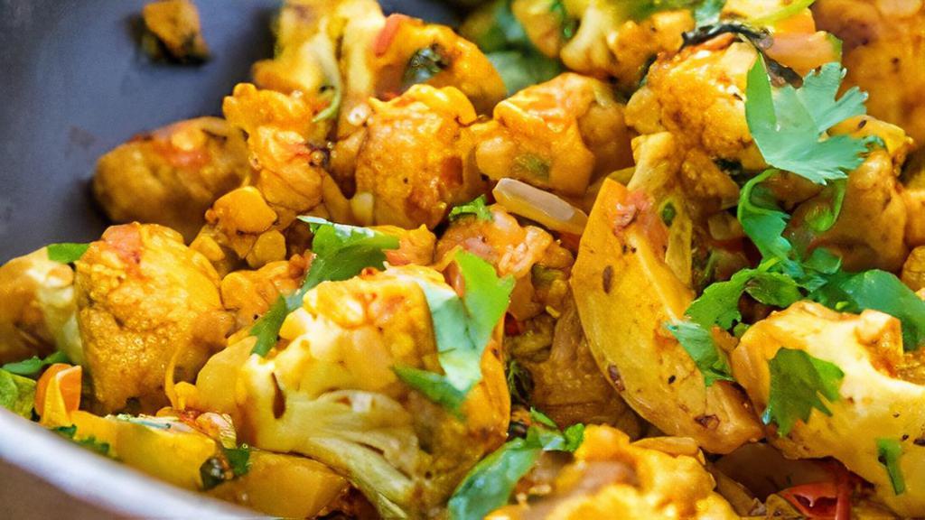 Aloo gobi · It is  a popular Indian dish in which potatoes and cauliflower are cooked with onions, tomatoes and spices