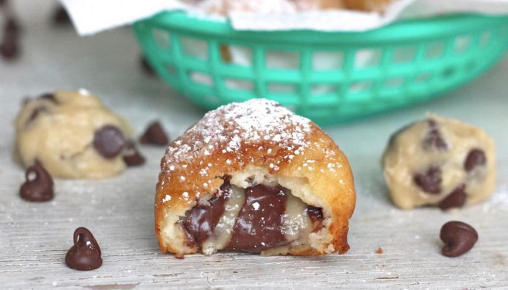 Cookie Dough · 4 chocolate chip cookie dough bites battered, topped with powdered sugar, and a side of chocolate.