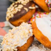 Two (2) Peanut Topped Cake Donuts · Variety of peanut cake donuts.