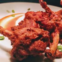 Chicken Lollipop · Chicken wings marinated in a house special sauce and deep fried. Garnished with onion and le...