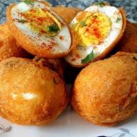 Egg Bonda · Boiled egg dipped into batter and deep fried. Served with mint and sweet chutney.