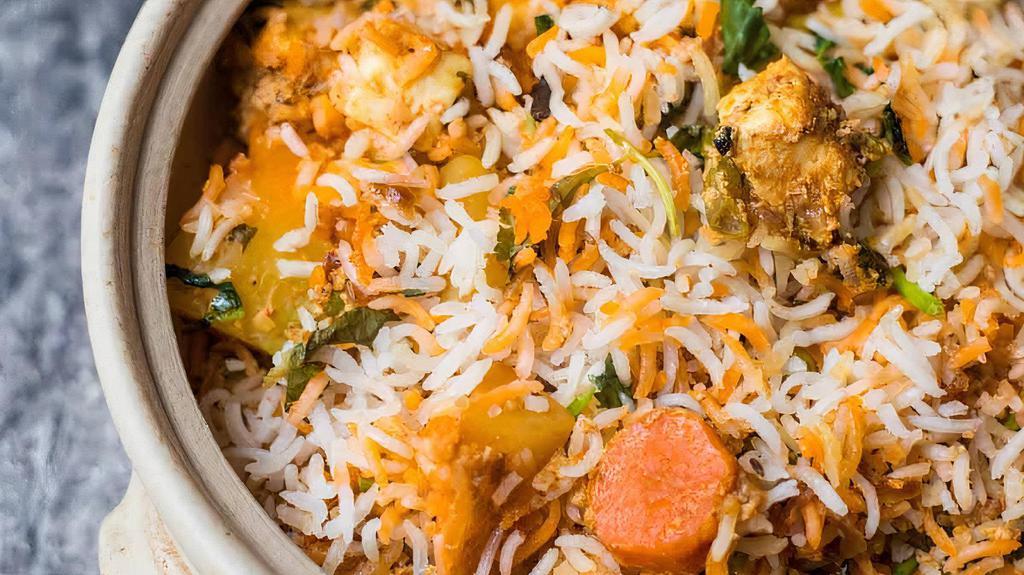 Hyderabad Veg Dum Biryani · A mixture of aromatic basmati rice, mixed vegetables, Indian herbs and our famous Hyderabadi biryani masala cooked in the traditional Hyderabadi dum style.