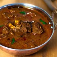 Chicoo's Special Goat Curry · A traditional spiced Indian curry with tender pieces of bone-in goat.