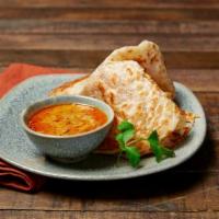 Platha & Dip · Handmade buttery multi-layered bread. Served with a side of coconut chicken or vegetarian cu...