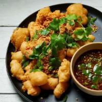 Salt & Pepper Calamari · Lightly battered, tossed with salt, peppers, scallions, and jalapeños. Sauce contains fish s...