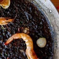 *Paella Negra · Squid ink, scallops, seasonal mushrooms, octopus, gulf shrimp & clams (gf)
