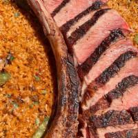 *Paella Tomahawk · 40 oz. Rib eye’s special cut served with our traditional bomba rice paella