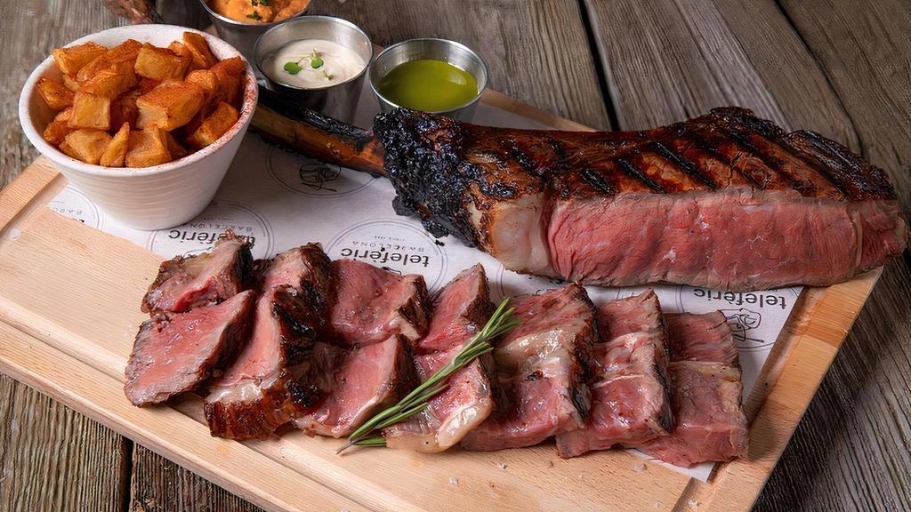 Catalan Tomahawk · Premium 'chuletón', potatoes and set of dressings (gfa) Allow 45 minutes to cook