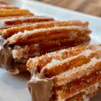 Churros con Nutella · Barcelona street friend dough filled with Nutella (nuts, v)