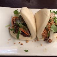Pork Belly Bao (2) · Taiwanese style sliders made with braised pork belly, candied peanuts, pickled cucumber, cil...