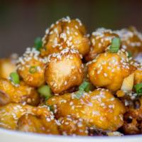 Sesame Glazed Chicken · Crispy natural chicken, sweet and tangy sesame glaze, chili pods, toasted sesame seeds.