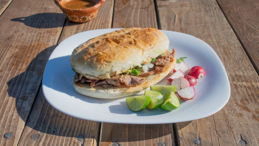 Al Pastor Torta · Delicious Torta filled with BBQ Pork, cheese, lettuce, tomato, guacamole, sour cream, jalapeños and mayo.