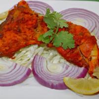 Tandoori Chicken · Marinated bone in chicken leg quarters, broiled in the tandoor oven, served in sizzling plat...