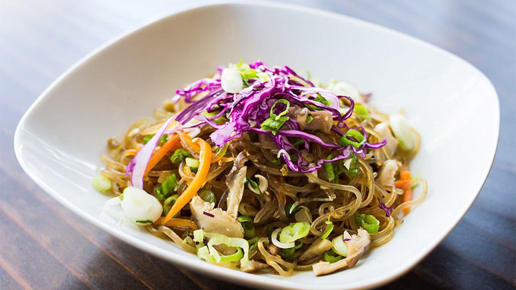 Veggie Jhap Chae · Sweet potato glass noodles stir-fried with mushrooms, julienned carrots, cabbage, onion, and sesame oil.