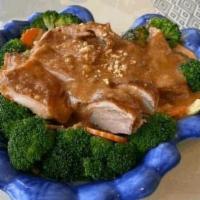 Crispy Duck w/ Peanut Sauce · Deep fried crispy duck, served with steamed vegetables topped with peanut sauce and ground p...