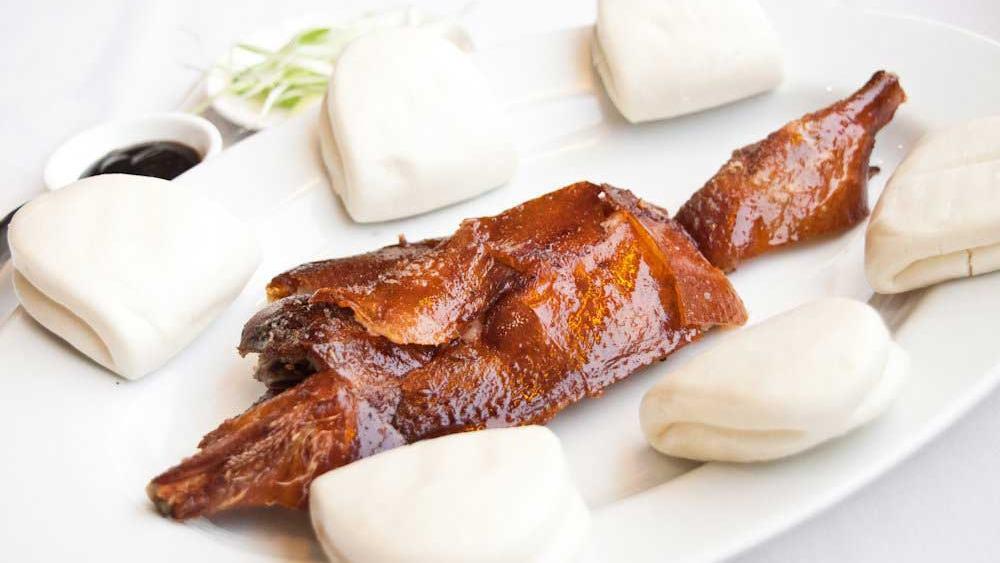 Peking Duck · Specially marinated duck, roasted to a golden brown skin. Served with steamed buns, scallions and hoisin sauce.