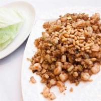 Minced Seafood in Lettuce Cups · Stir fried minced seafood, Chinese sausage, mushrooms, and bamboo shoots topped with pine nu...