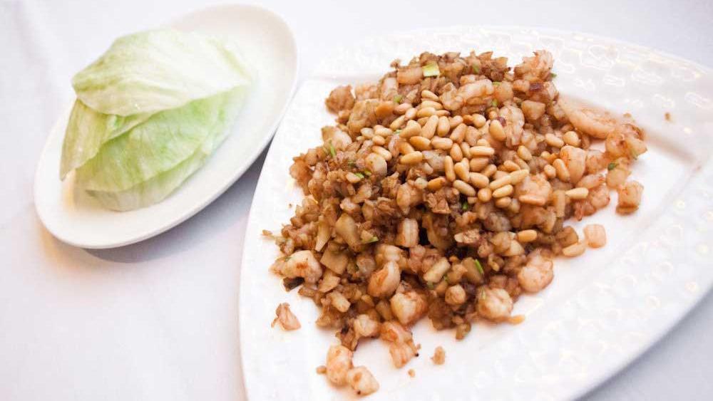Minced Seafood in Lettuce Cups · Stir fried minced seafood, Chinese sausage, mushrooms, and bamboo shoots topped with pine nuts. Served with six lettuce cups.