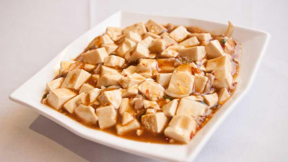 Ma Po Tofu · Soft bean curd, shredded pork, and scallions sautéed in a spicy sauce.
