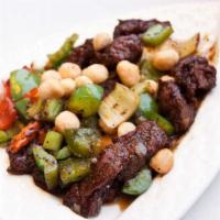 Steak Cubes with Macadamia Nuts · Tender beef steak cubes tossed with macadamia nuts, bell peppers and celery in a black peppe...