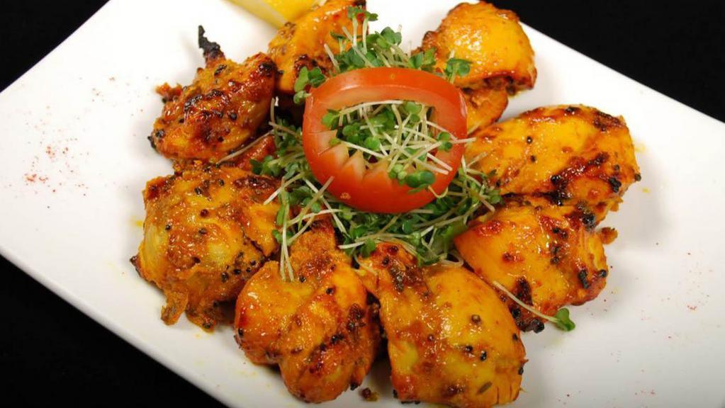 TANDOORI ACHARI CHICKEN TIKKA · Chicken cubes marinated in pickled spices, finished in clay oven