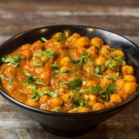 Chana Masala · Simmered and Tender Garbanzo cooked with, tomatoes and onions blend of Spices.
