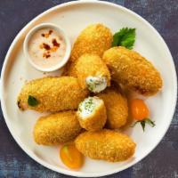 Hot Shot Poppers · Fresh jalapenos coated in cream cheese and fried until golden brown. Served with jalapeno ra...