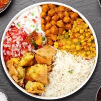 Delhi Style Bowl · Smashed Samosa and Aloo tikki served over rice with grill onion and Kachumber salad