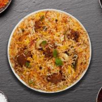 Goat Biryani · Tender goat cubes cooked with Indian spices and basmati rice. Served with house raita.