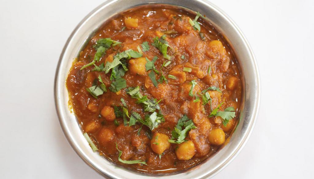 CHANNA MASALA* · Channa cooked with finely chopped onion, tomato and spices.
