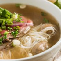 #32. Vietnamese Beef Noodle Soup (Pho) · Combination of rare steak, well done flank, beef meat balls, red onions, cilantro in traditi...