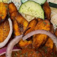 White rice platter · slowly cooked white rice. Served with plantain, cucumber, choice of meat and choice of stew/...