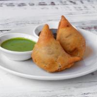 Samosas · A triangular fried pastry with a savory fillings, such as spiced potatoes, onions, and peas....