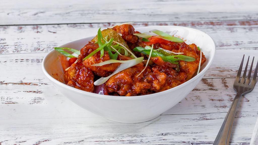 Chilli Chicken · Crispy marinated chicken sautéed in a spicy sweet sauce and cooked with onions, bell peppers and chili sauce.
