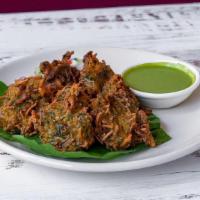 Vegetable Vajia (Pakoras) · Crispy fried vegetable fritters coated with chickpea flour. Consisting of carrots, cauliflow...