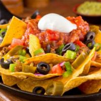Vegetarian Nachos · Delicious Nacho chips topped with beans, cheese, sour cream, avocados, lettuce, tomato, and ...