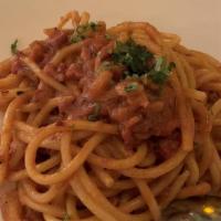 Bucatini Amatriciana · Hollow spaghetti with pancetta in a spicy tomato sauce.