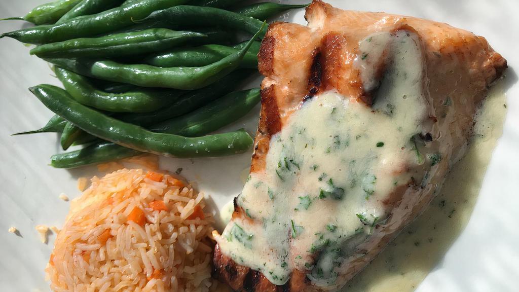 Grilled Atlantic Salmon · Grilled salmon filet with a lemon butter sauce served with mashed potatoes and spinach